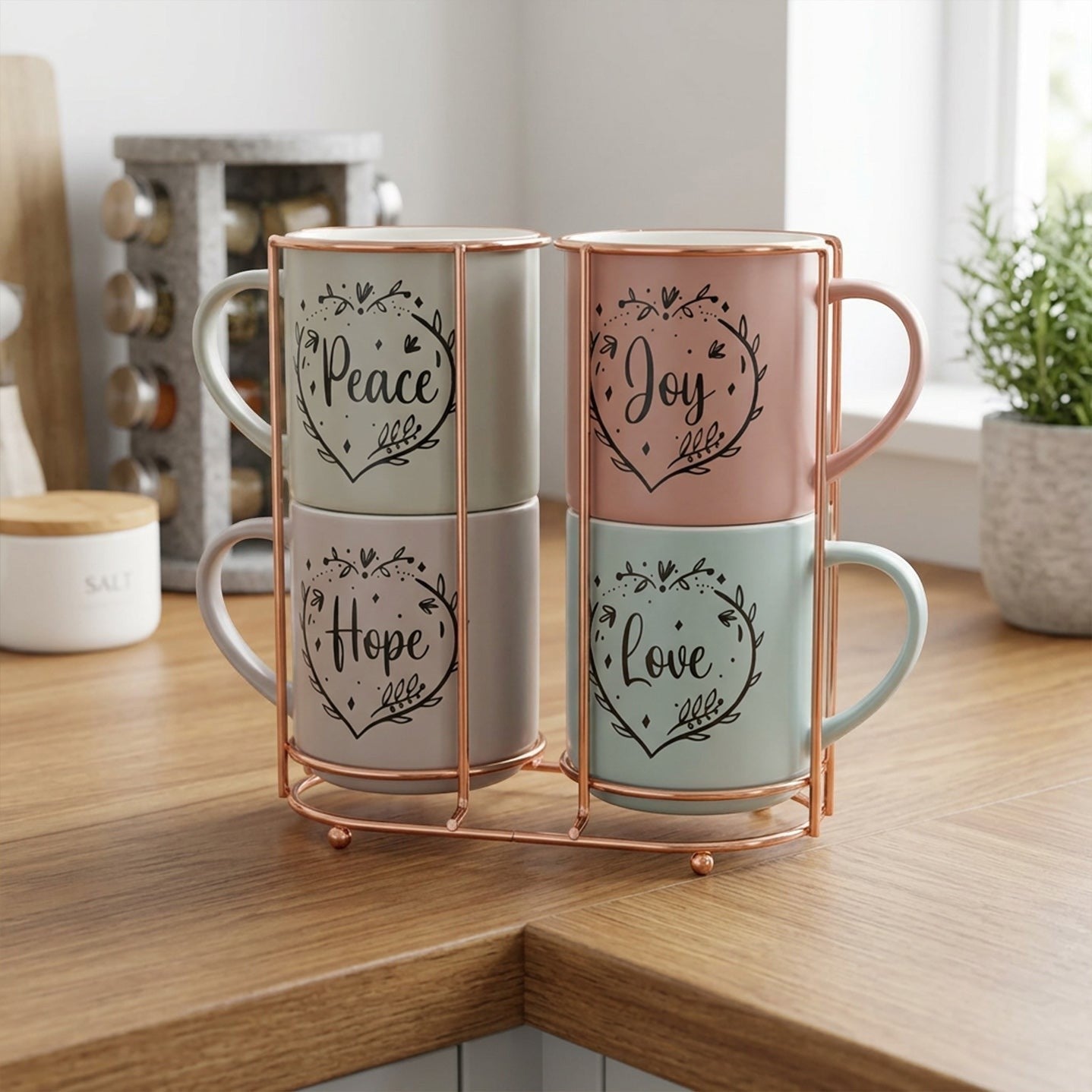 Home Appeal set of 4 mugs in pastel pink, sage green, light grey, and dusty rose, each with a heart design and inspirational word, on a copper stand.
