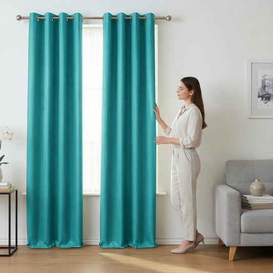 Home Appeal teal textured grommet top curtains hanging in a living room with a woman adjusting them.